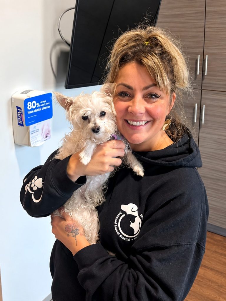 Kristin hugging a fluffy white patient